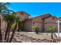 Charming single-story home featuring a two-car garage, desert landscaping with palms, and a well-maintained front yard at 12941 W Flower St, Avondale, AZ 85392