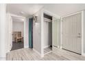 Inviting entryway with tiled floors, mirrored closet, and updated lighting at 1342 W Emerald Ave # 381, Mesa, AZ 85202
