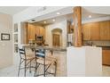 Charming kitchen featuring a breakfast bar, wooden accents, and stainless steel appliances at 13600 N Fountain Hills Blvd # 405, Fountain Hills, AZ 85268