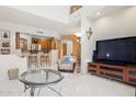 Open living room with breakfast bar, television, and tiled floors at 13600 N Fountain Hills Blvd # 405, Fountain Hills, AZ 85268
