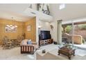 Spacious living room with high ceilings, tile flooring, and sliding glass doors to the patio at 13600 N Fountain Hills Blvd # 405, Fountain Hills, AZ 85268