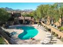 Aerial view of a community pool and spa surrounded by lounge chairs and desert landscaping at 13600 N Fountain Hills Blvd # 405, Fountain Hills, AZ 85268