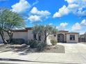 Charming single-story home featuring well-maintained landscaping and desert plants in the front yard at 14437 W Lexington Ave, Goodyear, AZ 85395