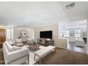 Bright living room featuring contemporary furniture, a large television, and an open layout perfect for entertaining at 14437 W Lexington Ave, Goodyear, AZ 85395