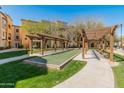 Outdoor bocce court under wooden pergola in a community setting at 14575 W Mountain View Blvd # 10313, Surprise, AZ 85374
