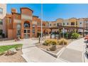 Community building with a charming archway, swimming pool, and pergola at 14575 W Mountain View Blvd # 10313, Surprise, AZ 85374