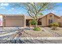 Charming single-story home featuring a well-manicured yard, xeriscaping, and a private two-car garage at 14655 N Kings Way, Fountain Hills, AZ 85268
