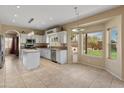 Spacious kitchen with white cabinets, stainless appliances, and island seating at 15055 S 40Th Pl, Phoenix, AZ 85044