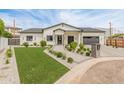 Beautiful single-story home features manicured landscaping, brick driveway, and inviting modern curb appeal at 1506 E Tuckey Ln, Phoenix, AZ 85014