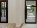 Home's foyer showcases a modern design with decorative doors and neutral color palette at 1506 E Tuckey Ln, Phoenix, AZ 85014