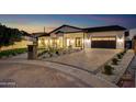 Charming single-story home features manicured landscaping, brick driveway, and inviting exterior lighting at 1506 E Tuckey Ln, Phoenix, AZ 85014
