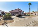 Attractive home with desert landscaping, a private yard, and a mature shade tree at 16150 N 86Th Ave, Peoria, AZ 85382