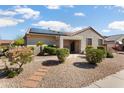 Charming home exterior with solar panels, desert landscaping, and a stone pathway at 16160 W Starlight Dr, Surprise, AZ 85374