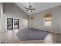Spacious living room with tile flooring, neutral colors, large windows and sliding glass door to backyard at 1683 W Maplewood St, Chandler, AZ 85286
