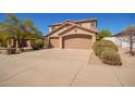 Charming two-story home with a three-car garage, desert landscaping, and solar panels at 17458 W Wandering Creek Rd, Goodyear, AZ 85338