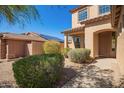 Inviting home exterior features a covered porch, beautiful landscaping and a well-maintained walkway at 17458 W Wandering Creek Rd, Goodyear, AZ 85338