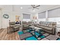 Open living room with a modern rug, comfortable couches, and ample natural light at 17850 N 68Th St # 1037, Phoenix, AZ 85054