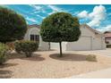 Inviting single-story home featuring desert landscaping, a spacious two-car garage and an attractive front yard at 18237 W Port Au Prince Ln, Surprise, AZ 85388