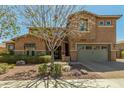 Charming two-story home boasts a well-manicured front yard and inviting curb appeal at 18483 W Paradise Ln, Surprise, AZ 85388