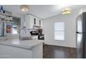 Modern kitchen featuring white cabinets, stainless appliances, and a sleek design at 201 S Greenfield Rd # 255, Mesa, AZ 85206
