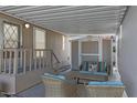 Cozy covered patio with wicker furniture and adjacent storage shed at 201 S Greenfield Rd # 255, Mesa, AZ 85206