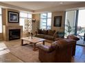 Inviting living room with fireplace, comfortable seating, and view of the outside greenery at 2211 E Camelback Rd # 604, Phoenix, AZ 85016