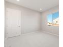 Neat bedroom features a bright window, neutral carpet, and fresh paint at 26930 W Renee Dr, Buckeye, AZ 85396