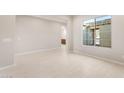 Bright living room with large window, neutral walls, and tile flooring at 26930 W Renee Dr, Buckeye, AZ 85396