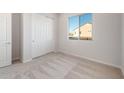 Bedroom featuring neutral carpet, a window, a closet with sliding doors and neutral paint at 26942 W Renee Dr, Buckeye, AZ 85396