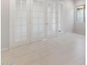 Bright room featuring white tile flooring, neutral walls and large paneled doors at 26942 W Renee Dr, Buckeye, AZ 85396