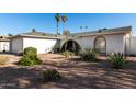 Landscaped front yard showcasing desert plants and an arched entrance to this lovely single Gathering home at 2717 W Medina Ave, Mesa, AZ 85202