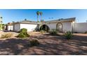 Landscaped front yard showcasing desert plants and an arched entrance to this lovely single Gathering home at 2717 W Medina Ave, Mesa, AZ 85202