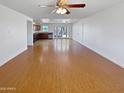 Bright and airy living room with hardwood floors and a view of the open kitchen and dining area at 3702 E Karen Dr, Phoenix, AZ 85032
