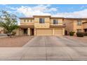 Inviting two-story home with a spacious three-car garage and well-maintained desert landscaping at 43724 W Cowpath Rd, Maricopa, AZ 85138