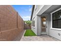 Private backyard featuring a patio, artificial turf, and a view of the surrounding landscape at 4383 N 203Rd Dr, Buckeye, AZ 85396