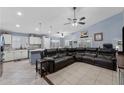 Spacious living room open to the kitchen, with a large leather sectional and natural light at 4407 E Meadow West Ln, Queen Creek, AZ 85140