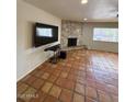 Living room showcases a stone fireplace, ceiling fan and large window with natural light at 5829 E Windsor Ave, Scottsdale, AZ 85257