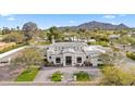 Stunning home featuring meticulous landscaping, lush greenery and a circular driveway for a grand arrival at 6129 E Turquoise Ave, Paradise Valley, AZ 85253