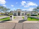 Elegant home boasts pristine landscaping, a beautiful walkway, and great curb appeal at 6129 E Turquoise Ave, Paradise Valley, AZ 85253