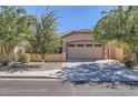 Inviting home showcasing desert landscaping, and a spacious driveway leading to a two-car garage at 7589 W Quail Track Dr, Peoria, AZ 85383