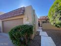 Charming single-story home features a well-maintained front yard, two-car garage, and tiled roof under a clear blue sky at 7843 E Valley View Rd, Scottsdale, AZ 85250