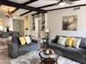 Open living room features beamed ceilings, neutral paint, and modern furnishings at 7843 E Valley View Rd, Scottsdale, AZ 85250