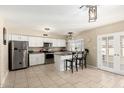 Bright kitchen featuring stainless steel appliances, white cabinets, and a cozy breakfast bar at 804 W Bentrup St, Chandler, AZ 85225