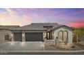 Beautiful home featuring a spacious three-car garage and professionally landscaped front yard with great curb appeal at 8154 E Jaeger St, Mesa, AZ 85207