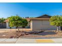 Lovely home exterior featuring desert landscaping and mature shade trees at 8656 E Plaza Ave, Scottsdale, AZ 85250