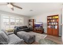 Cozy living room with recessed lights, TV, ceiling fan, and hardwood floors at 8656 E Plaza Ave, Scottsdale, AZ 85250