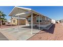 Single-level home featuring a spacious carport, complemented by desert landscaping at 9431 E Coralbell Ave # 178, Mesa, AZ 85208