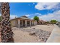 Charming single-story home featuring a desert landscape, covered porch, and attached two-car garage at 10001 W Potter Dr, Peoria, AZ 85382