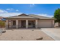 Charming single-story home featuring a desert landscape, covered porch, and attached two-car garage at 10001 W Potter Dr, Peoria, AZ 85382