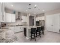 Kitchen featuring white cabinets, granite countertops, stainless steel appliances, and a kitchen island at 19011 E Carriage Way, Queen Creek, AZ 85142